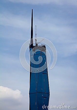 Partial view of Warisan Merdeka Tower against cloudy sky in Kuala Lumpur, Malaysia Editorial Stock Photo