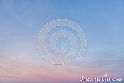 Partially Cloudy Pastel Pink and Purple Dusk Light with Blue Sky Stock Photo