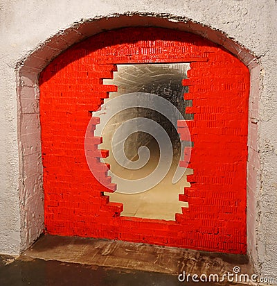 A partially destroyed passage to a mysterious tunnel, a passage to a tunnel laid with red bricks, a dungeon Stock Photo
