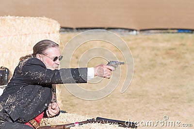 Participant dressed in period cowboy costume, portraying gunfig Editorial Stock Photo