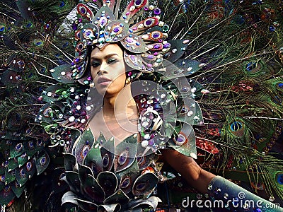 A participant in her colorful costume at a parade during the Sumaka Festival in Antipolo City. Editorial Stock Photo