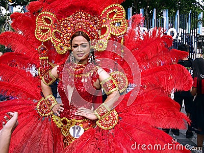 A participant in her colorful costume at a parade during the Sumaka Festival in Antipolo City. Editorial Stock Photo