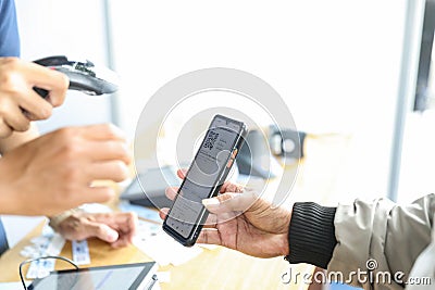 a participant registers himself by scanning a barcode by the committee Stock Photo