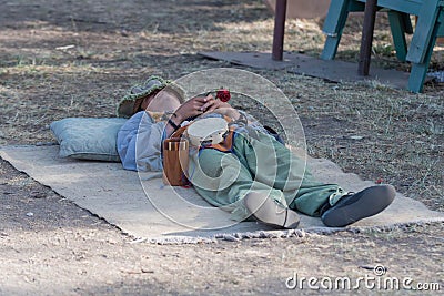 Participant wearing vintage clothes, sleeping on the floor Editorial Stock Photo