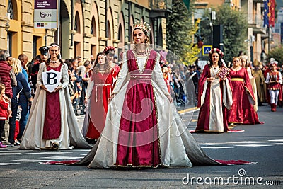 Participants in historic dresses on Medieval Parade in Alba, Italy. Editorial Stock Photo