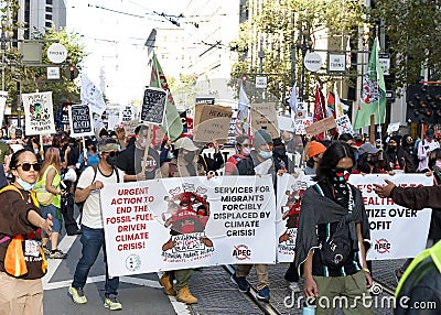 Participants holding signs marching and protesting APEC meeting in San Francisco, CA Editorial Stock Photo
