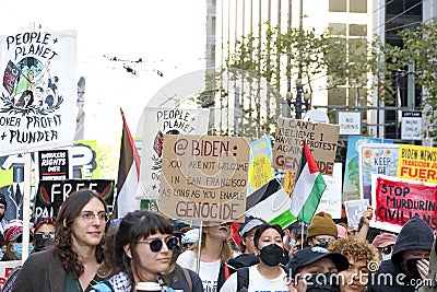 Participants holding signs marching and protesting APEC meeting in San Francisco, CA Editorial Stock Photo