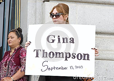 Participants holding signs of recently murdered women at a Domestic Violence Awareness Month Rally Editorial Stock Photo