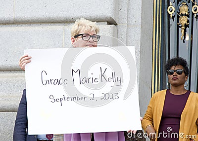 Participants holding signs of recently murdered women at a Domestic Violence Awareness Month Rally Editorial Stock Photo