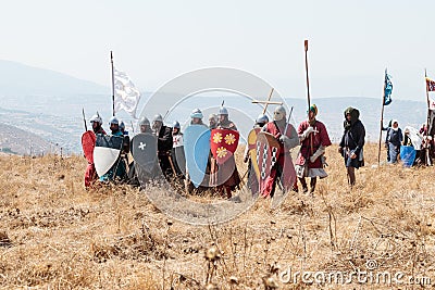 Participants in the reconstruction of Horns of Hattin battle in 1187 dressed in crusader suits, are preparing to repel an attack o Editorial Stock Photo