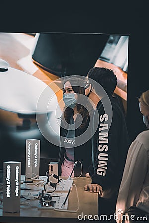 Participants showing technology devices during the Korean Festival Auckland at trust arena Editorial Stock Photo