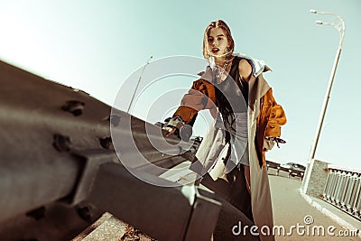 Stunning good-looking model wearing layered outfit with jeans shorts Stock Photo