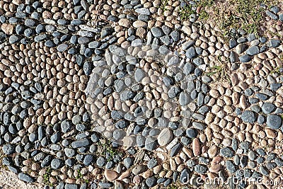 Particolore structure of some streets made of sea stones, in old street in medieval town. Stock Photo