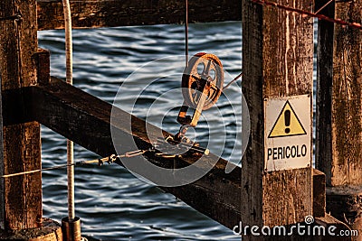 Particular, pulley of a scale, the poles are connected to motors by cables and pulleys in order to hoist the heavy net Stock Photo