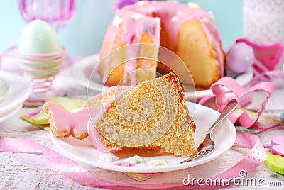 Partly sliced easter ring cake with pink icing Stock Photo