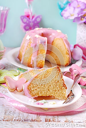 Partly sliced easter ring cake with pink icing Stock Photo