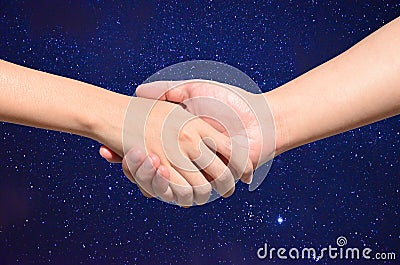 Partner hand between man and woman on Night sky Stock Photo