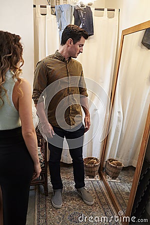 Partner and man trying on clothes in changing room, vertical Stock Photo
