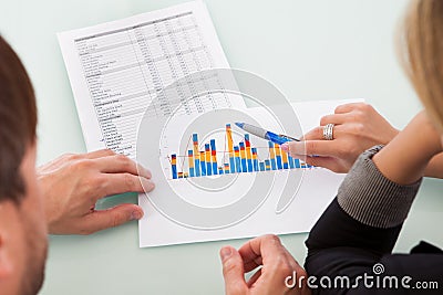 Partners discussing a business graph Stock Photo
