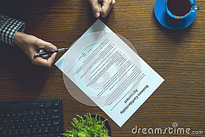 Partnership agreement business document signed by a person on the table in the office Stock Photo