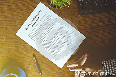 Partnership agreement business document signed by a person on the table in the office Stock Photo