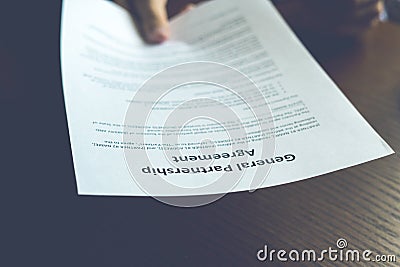 Partnership agreement business document signed by a person on the table in the office Stock Photo