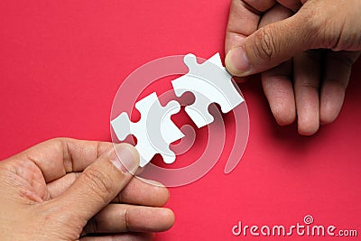 Partnership concept with hands putting puzzle pieces together Stock Photo