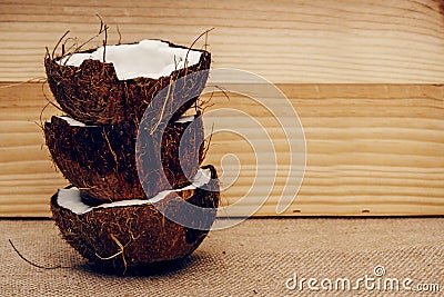 Parts of coconut on a colored background. Close up. Fresh ripe coconut broken into pieces. Stock Photo