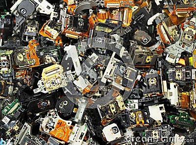 Parts of old optical drives as industrial waste background Editorial Stock Photo