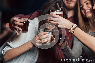 Party with alcohol. Group of young friends smiling and making a toast in the nightclub Stock Photo