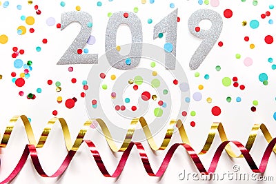 2019 party background with confetti and paper streamers on white background. Stock Photo