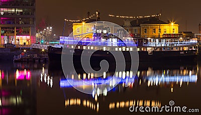 Party boat with lights on river liffey dublin ireland at night uk Editorial Stock Photo