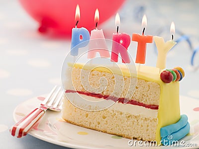 Party Candles on a Slice of Birthday Cake Stock Photo