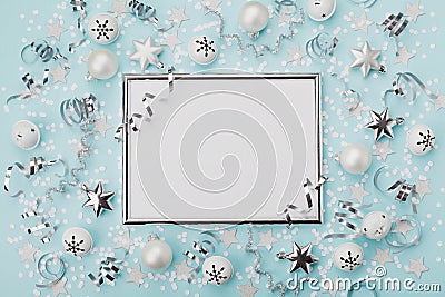 Party carnival christmas background decorated silver frame with confetti, balls and star on turquoise desk top view. Flat lay. Stock Photo