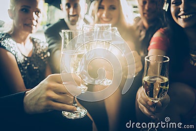 Party crowd clinking glasses with champagne Stock Photo