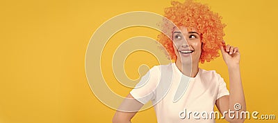 Party fun wig. cheerful funny girl with fancy look wearing orange hair wig on yellow background, cool. Woman isolated Stock Photo