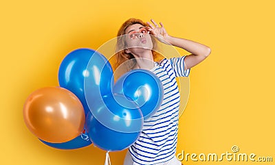 party girl with balloon in sunglasses. positive girl hold party balloons in studio. Stock Photo