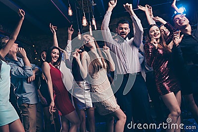 Party hard stay all nigh concept. Buddies dancing having fun active dynamic discotheque raise hands feel content dress Stock Photo