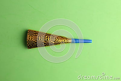 Party noisemaker on a green background Stock Photo