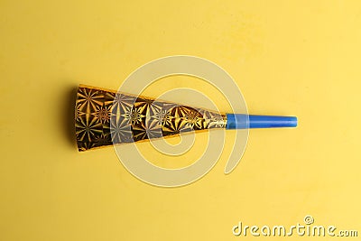 Party noisemaker isolated on a yellow background Stock Photo