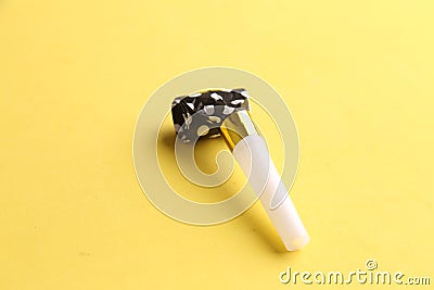 Party noisemaker isolated on a yellow background Stock Photo