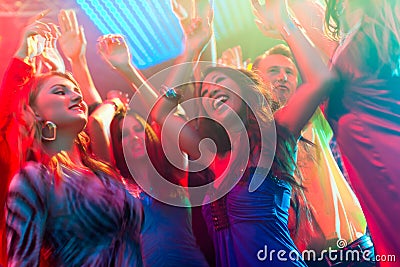 Party people dancing in disco or club Stock Photo