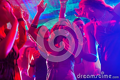 Party people dancing in disco or club Stock Photo