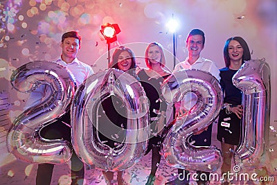 Party, people and new year holidays concept - women and men celebrating new years eve 2021 Stock Photo