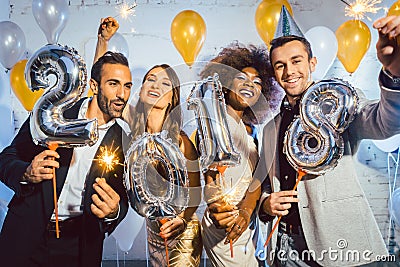 Party people women and men celebrating new years eve 2018 Stock Photo