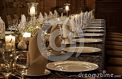 Party table setting lit by candles Stock Photo