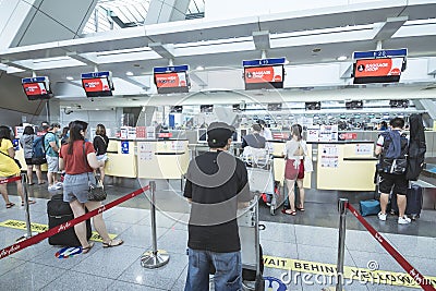 Pasay, Metro Manila, Philippines - Passengers line into the check-in counters of Air Asia at NAIA Terminal 3 Editorial Stock Photo