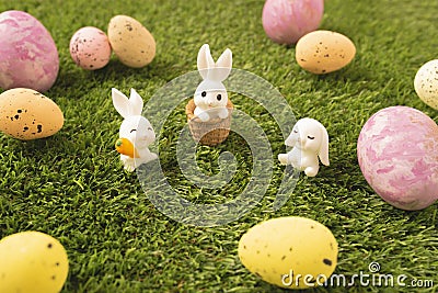 Paschal eggs with cute bunnies on the green lawn Stock Photo