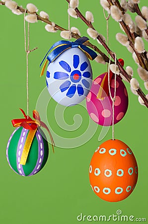 Paschal eggs on willow bouquet, vertical over green Stock Photo