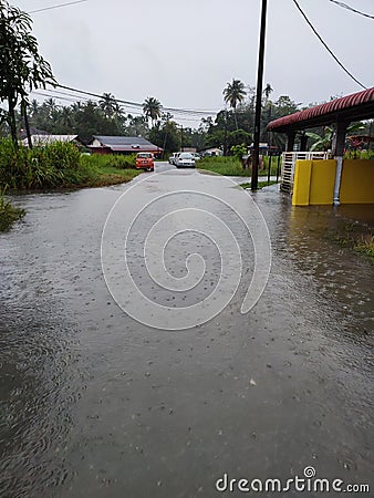 Pasir Puteh, Kelantan - February 27, 2022 : An road under water. Flooded cars on streets of the village. flood disaster Editorial Stock Photo